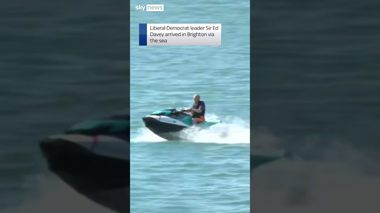 Ed Davey arrives at conference on jet ski