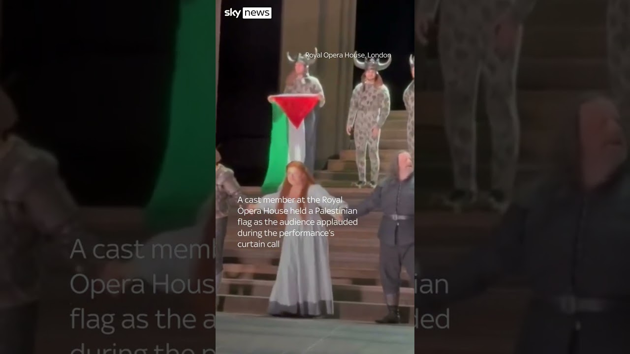 Performer holds Palestinian flag on stage at Royal Opera House