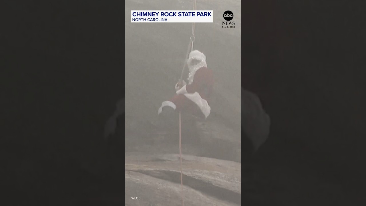 Santa rappels down Chimney Rock as he warms up for Christmas Eve