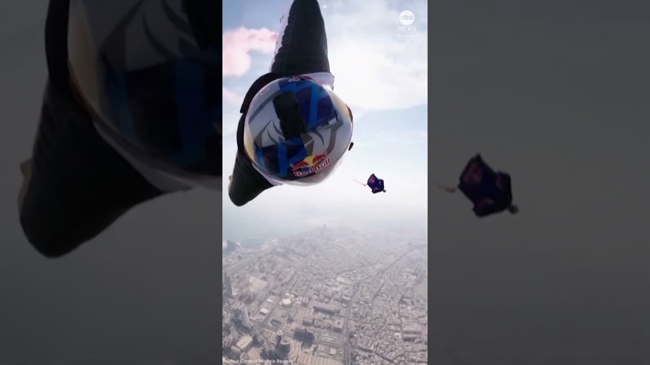 Wingsuit flyers perform daring between-tower stunt