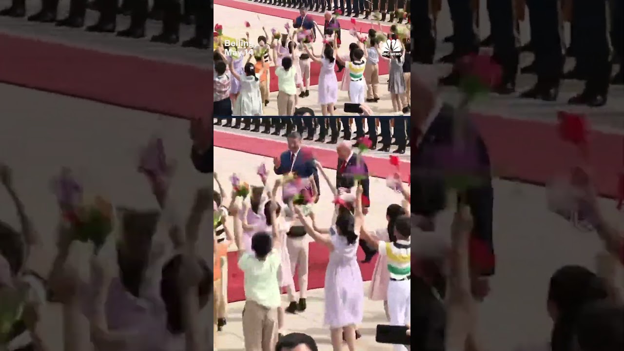 Children outside of the Great Hall of the People in Beijing greet President Trump