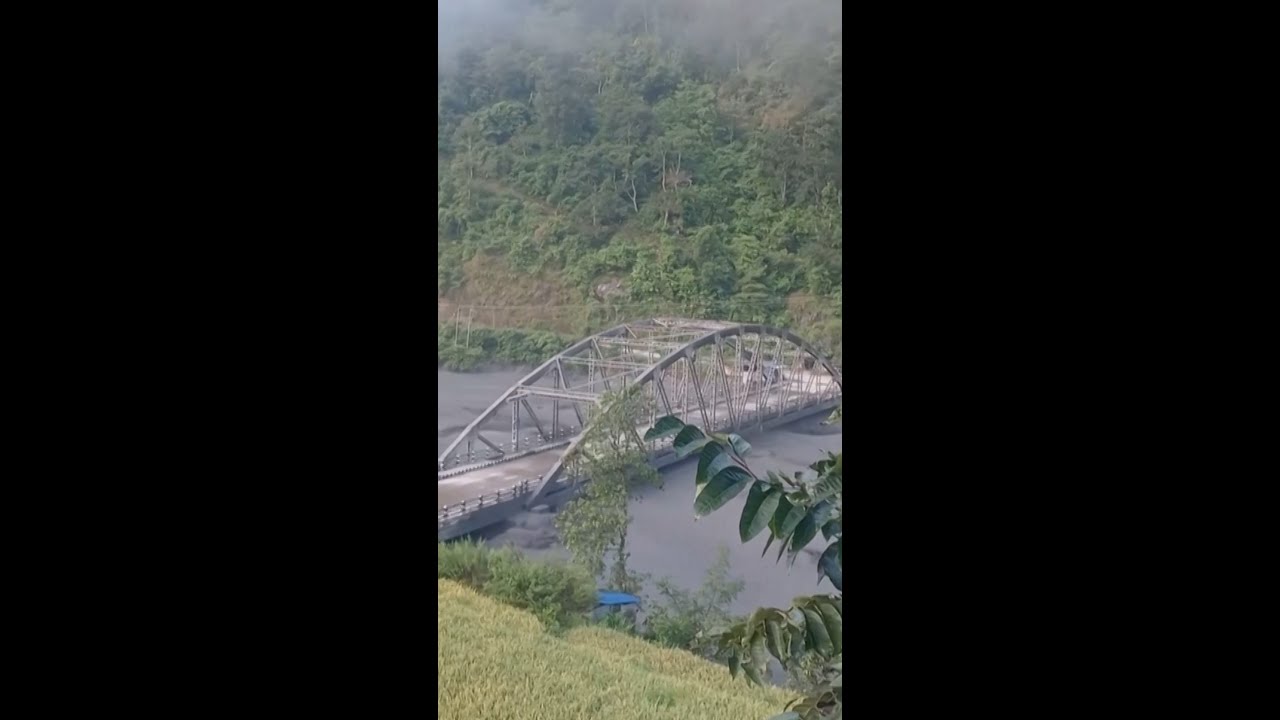 Bridge collapses after being knocked by floodwaters