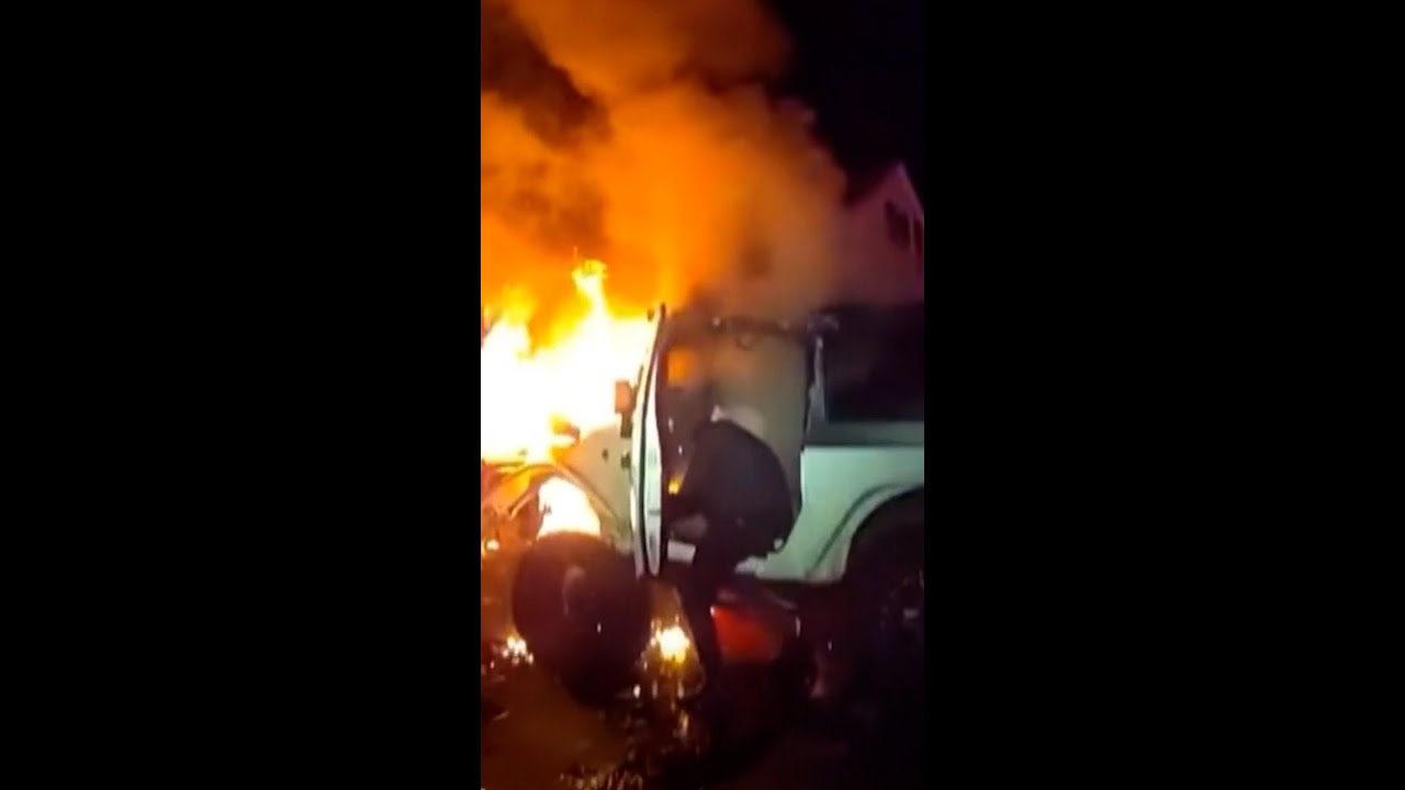 Trapped driver rescued from burning car